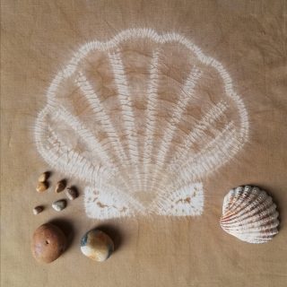 white shell design on brown background