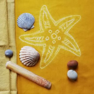 cream patterned starfish on gold background