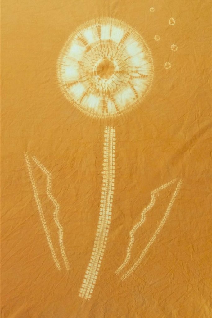 gold fabric with dandelion design