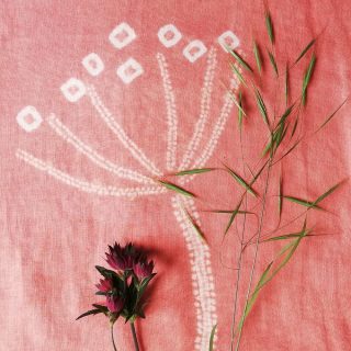 white hogweed pattern on pink fabric