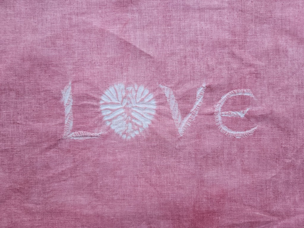 Stitch “Love” with Shibori: A Step-by-Step Guide 1 Stitch love with shibori - finished and dyed fabric - white letters on pink