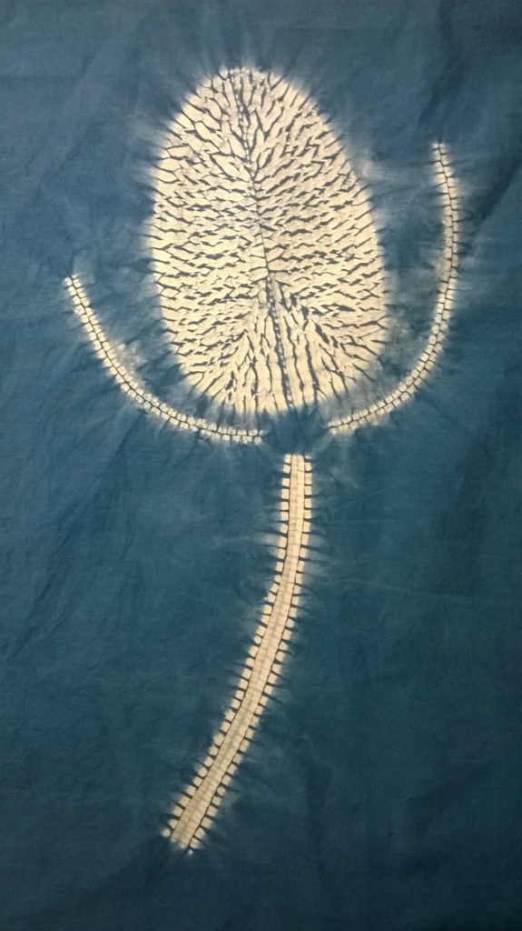 Designing with Miru Shibori 4 Original Ideas to Inspire You. 6 white design on ablue background of a miru shibori teasel