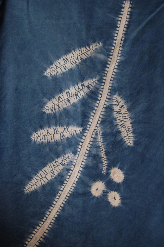 How to Shibori with Natural Dyes 2 leaves and stem white design on an indigo background