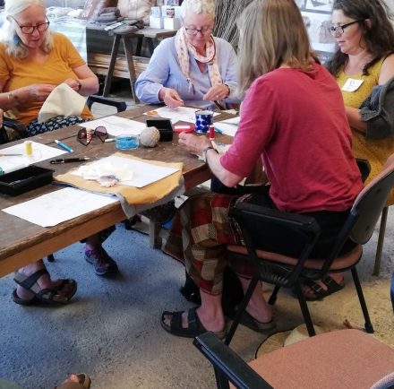 women sewing shibori together on a Townhill Studio shibori workshop